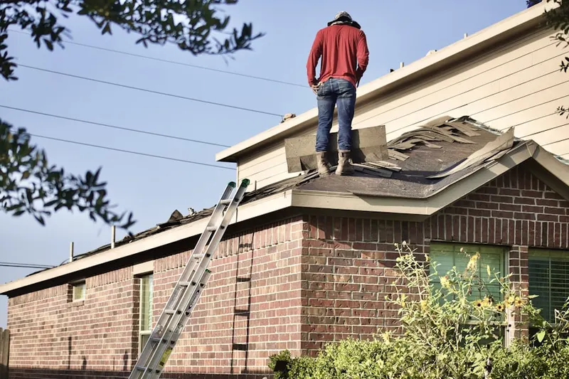 Professional roofer working on a residential roof in Larkspur